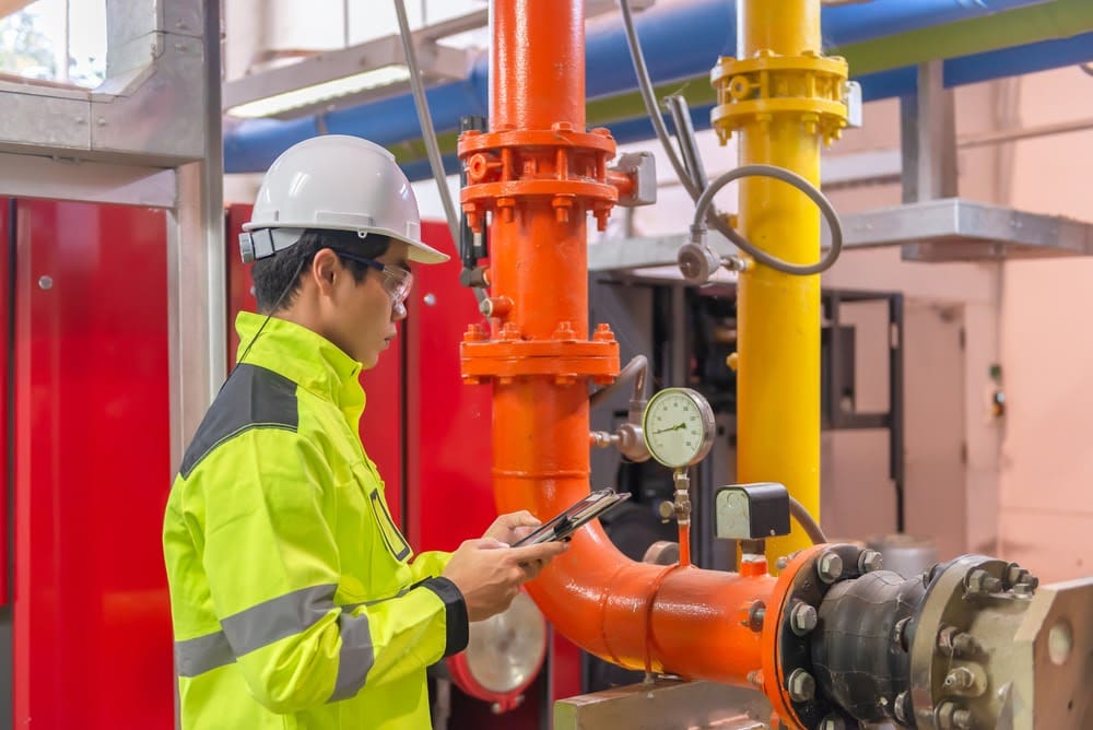 Electrician inspecting industrial equipment.
