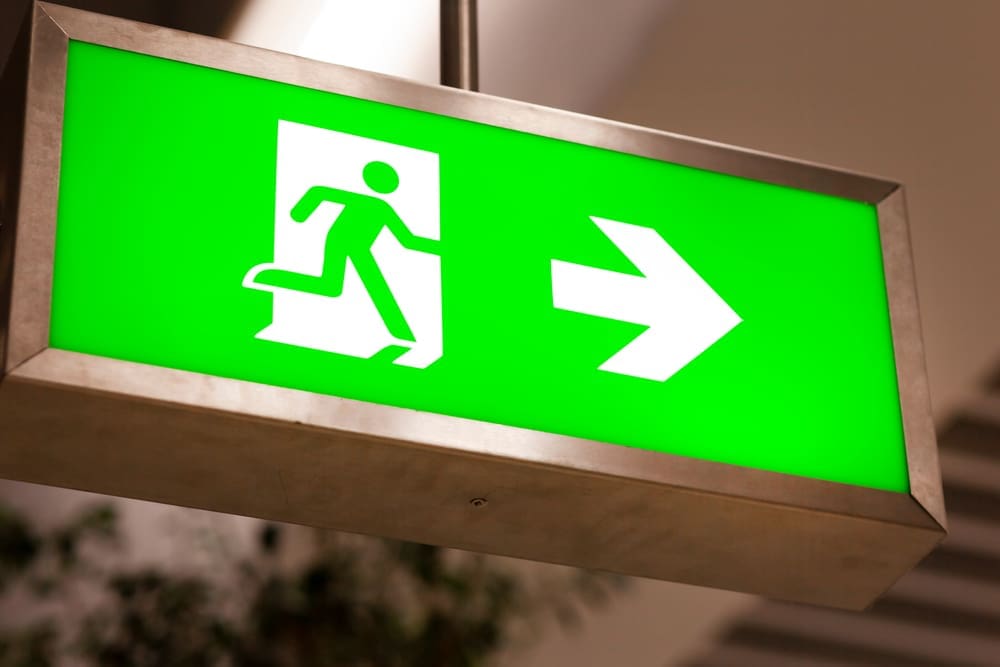 Green emergency exit signage with running figure