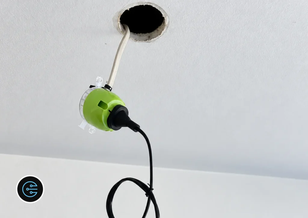Green plug-in connector and cable ready for a new LED downlight in a Malvern ceiling