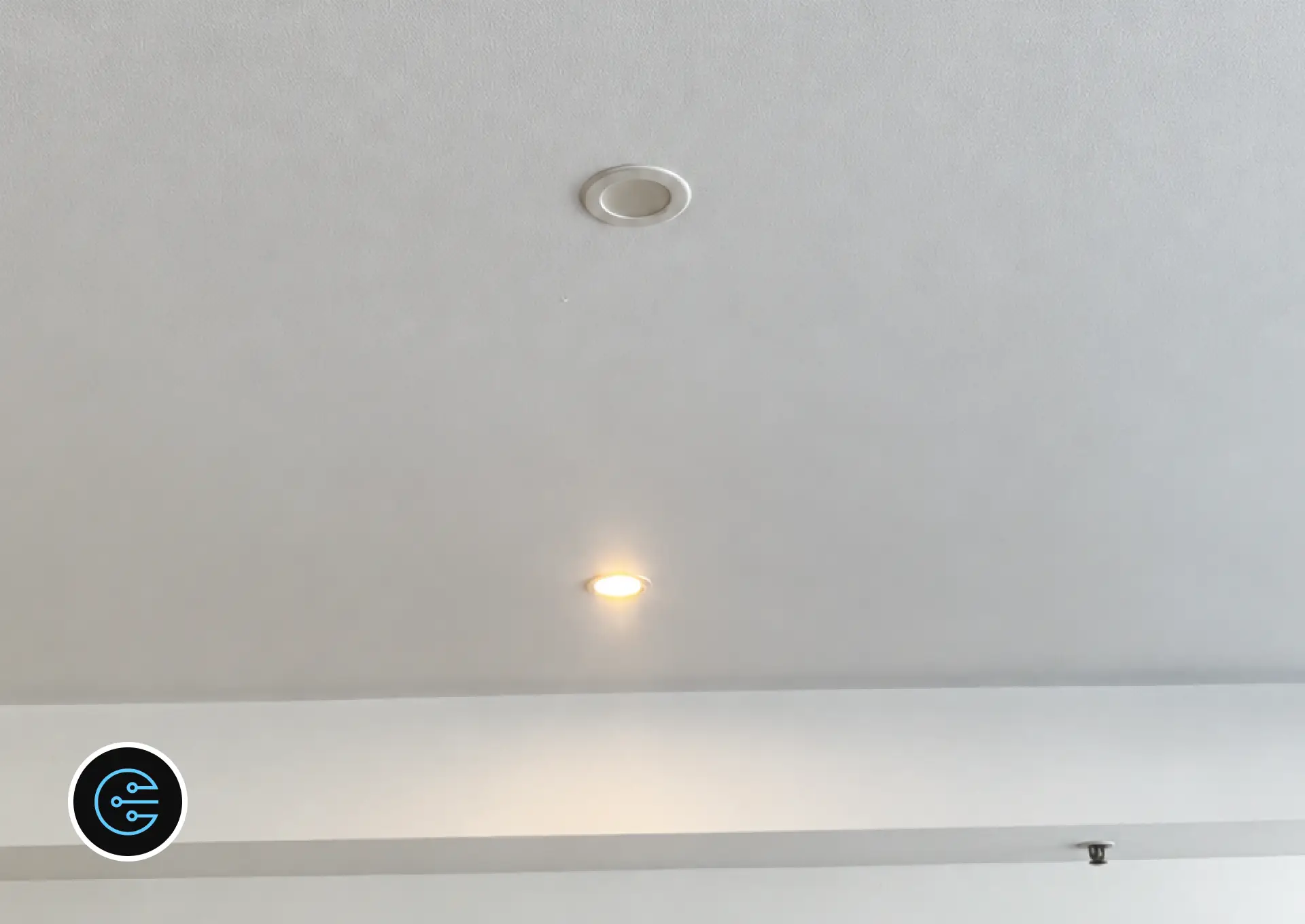 Newly installed LED downlights in a Malvern ceiling with one switched on