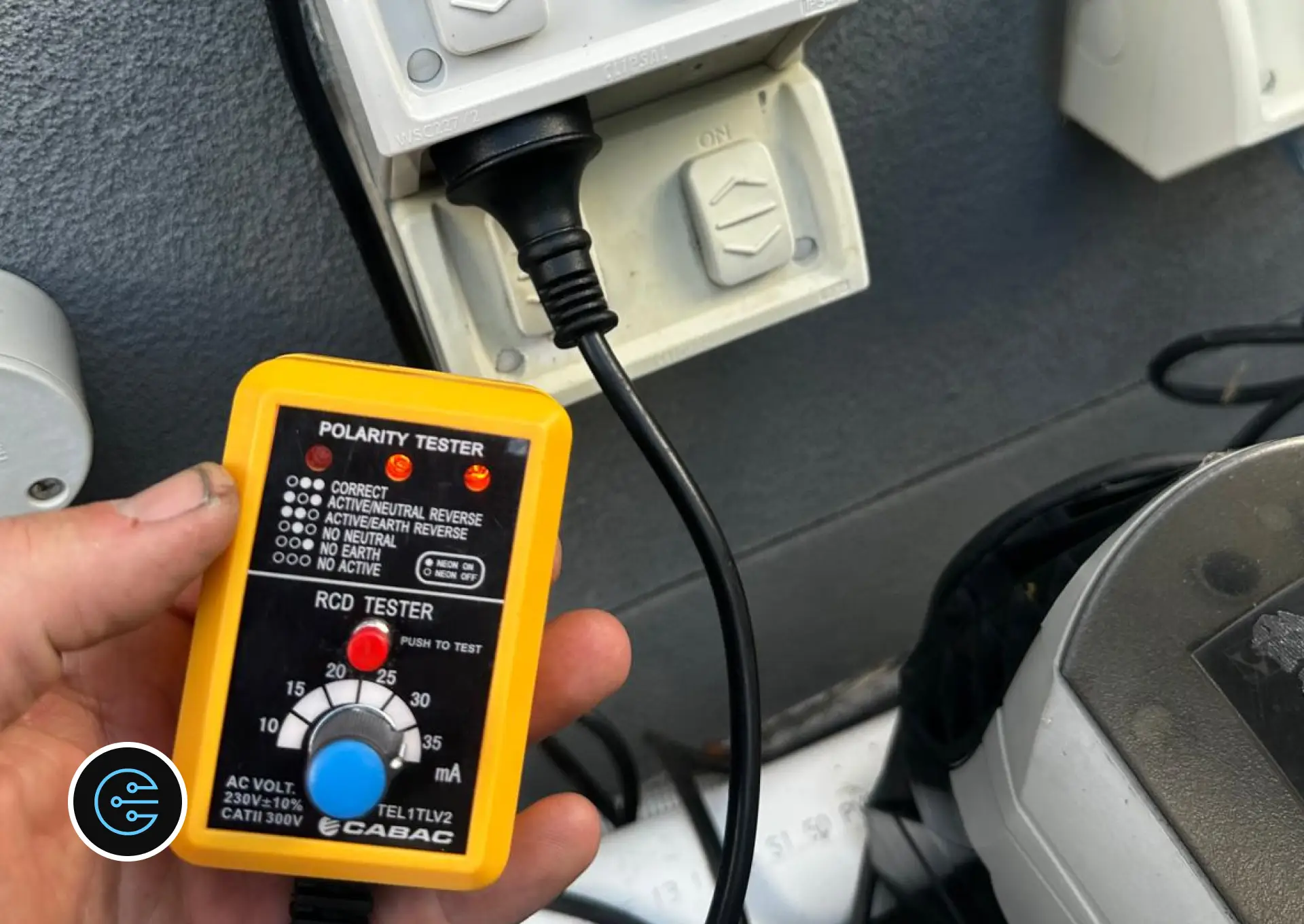 Leonard at All Electrics holding a polarity and RCD tester plugged into the new outdoor power point.